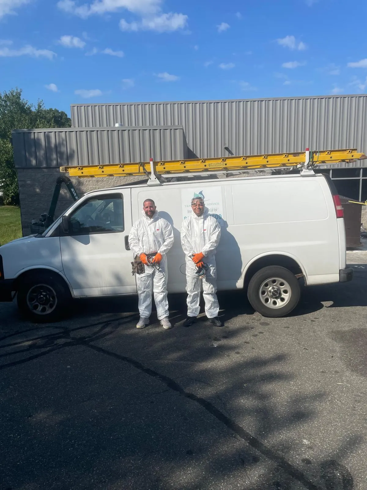 Duct cleaning technicians in protective suits ready for sanitization service