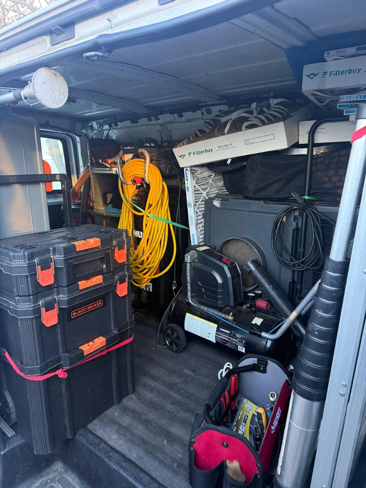 Professional duct cleaning equipment inside service van with air compressor and Filterbuy replacement filters